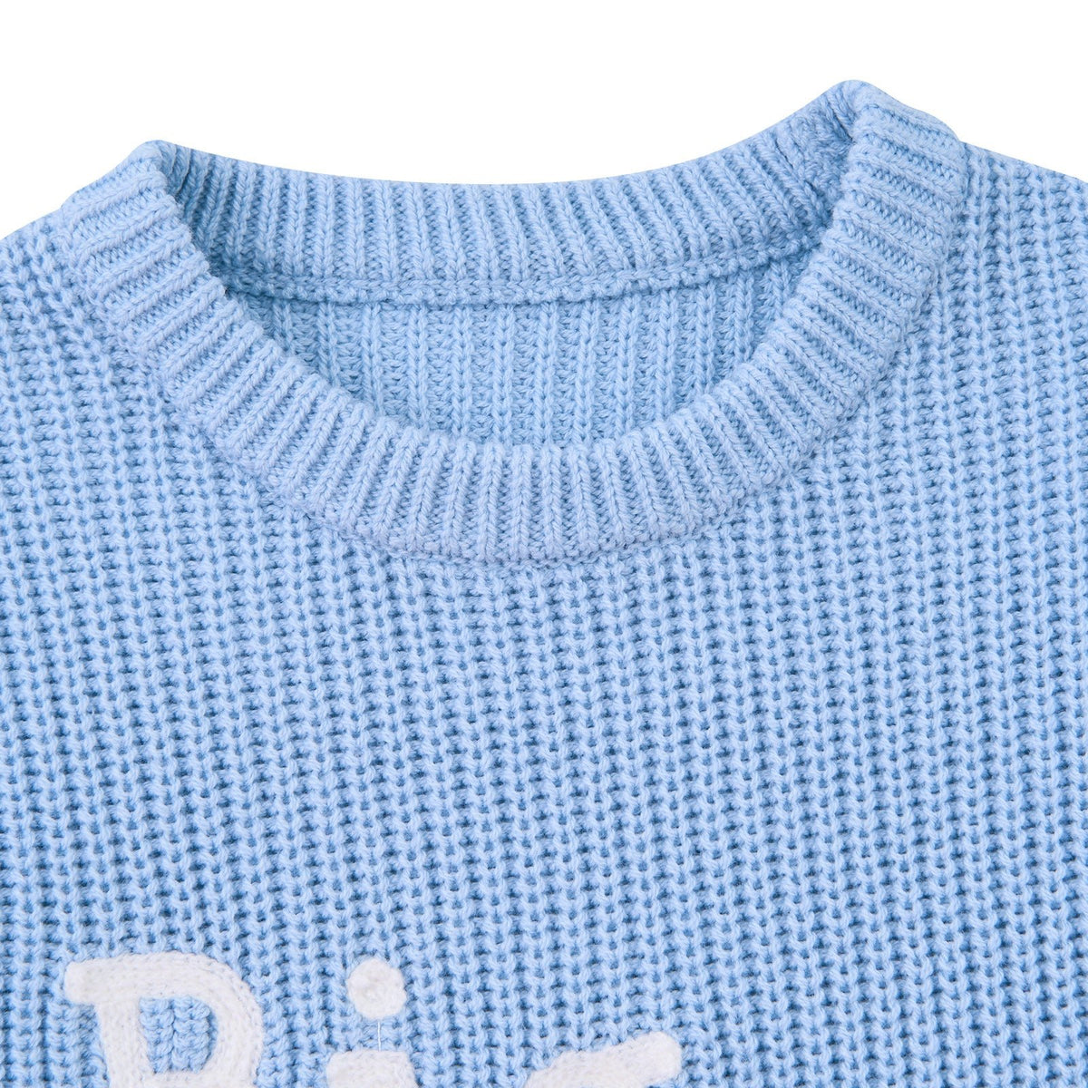 Close-up of the baby blue Big Brother sweater showing the crew neckline, ribbed trim and soft cotton acrylic fabric construction.