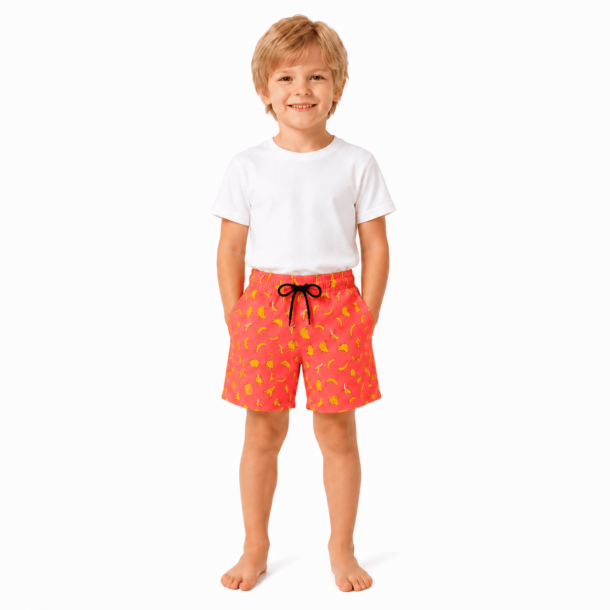 Young boy wearing orange banana print swim shorts with matching family beachwear style, comfortable kids swimwear for summer.