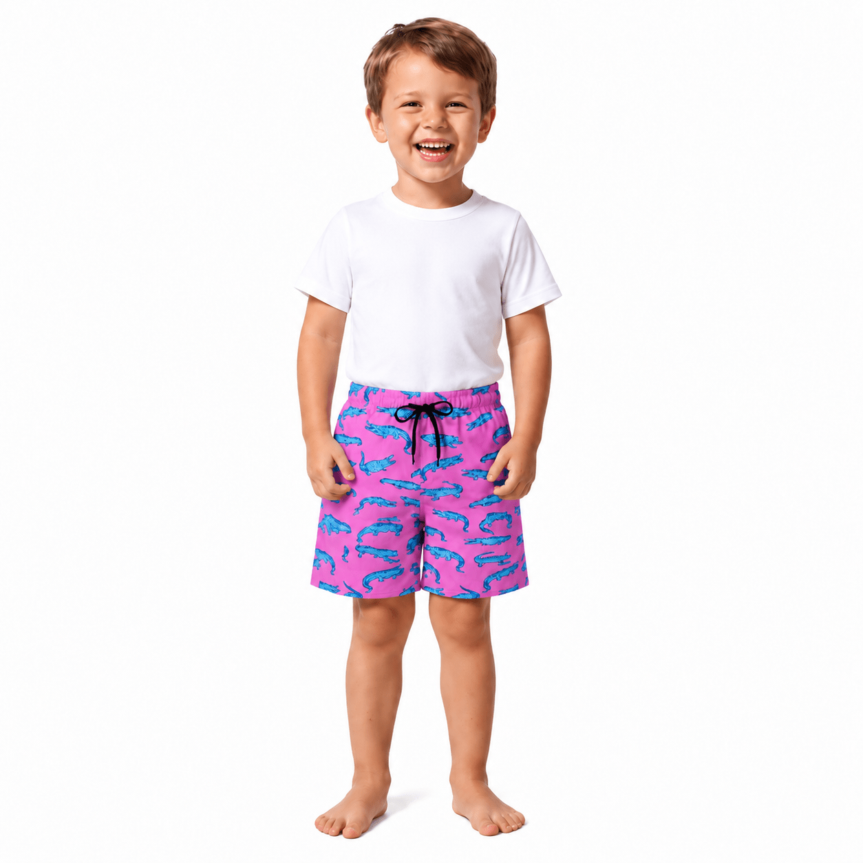 Kleiner Junge trägt rosa Badeshorts mit Krokodilmuster im passenden Familien-Bademode-Stil zum Schwimmen und für Urlaubsaktivitäten.