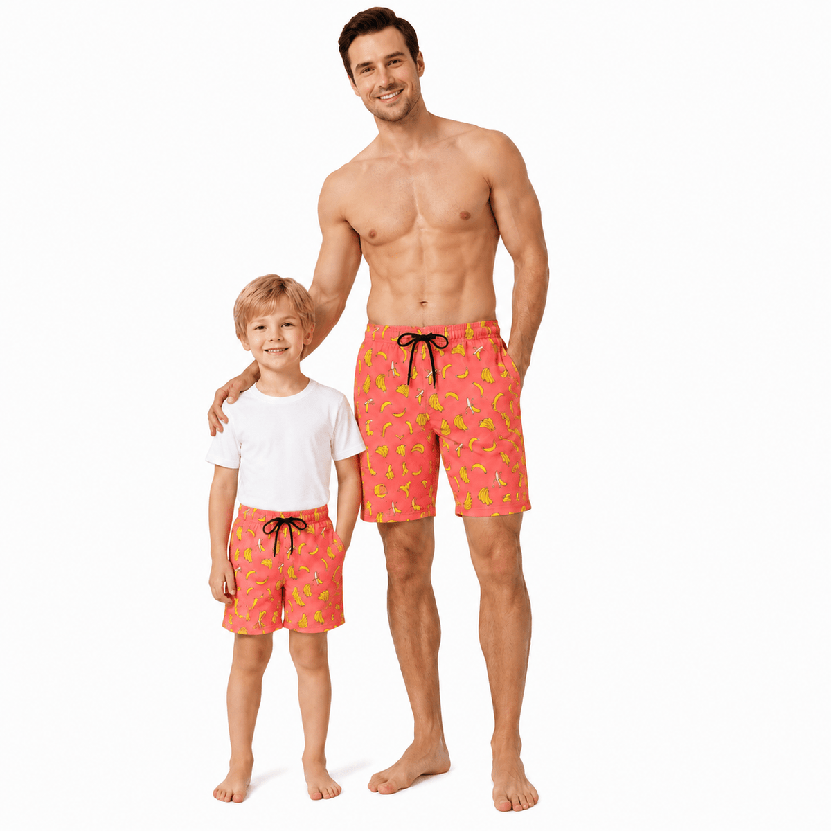 Father and son wearing matching orange banana print swim trunks, fun family swimwear set for beach vacations and summer days.