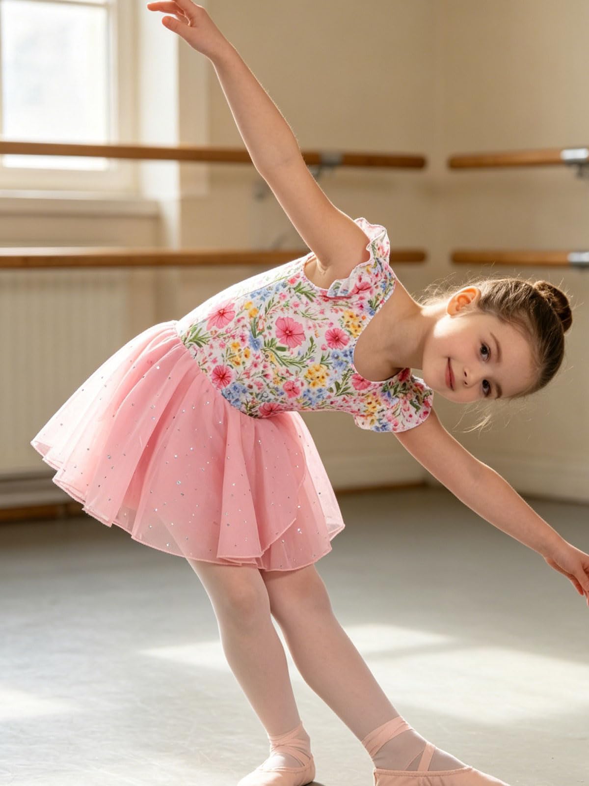 Girl spinning in a ballet dance dress with layered sequin skirt, showing the comfortable fit and elegant movement of kids dancewear.