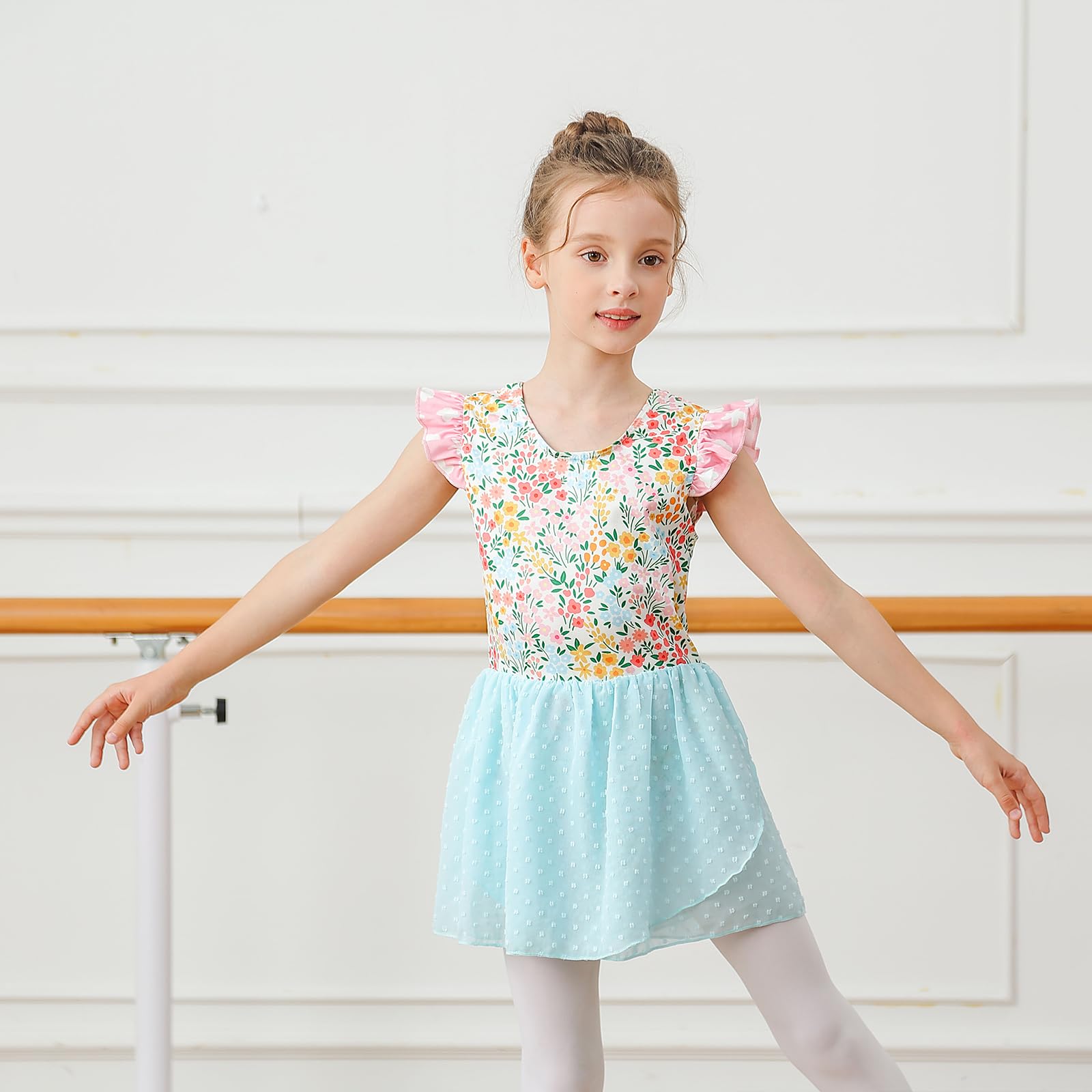 Young girl wearing ballet leotard dress while dancing, flexible stretch fabric and layered skirt designed for movement.