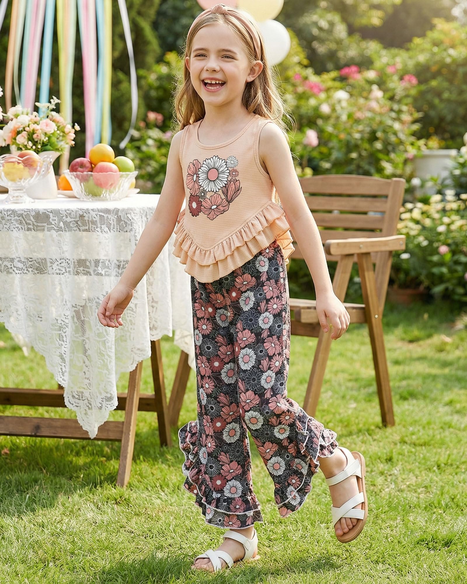 Girl wearing a two piece summer outfit with ruffle top and loose pants, perfect for outdoor play and vacations.