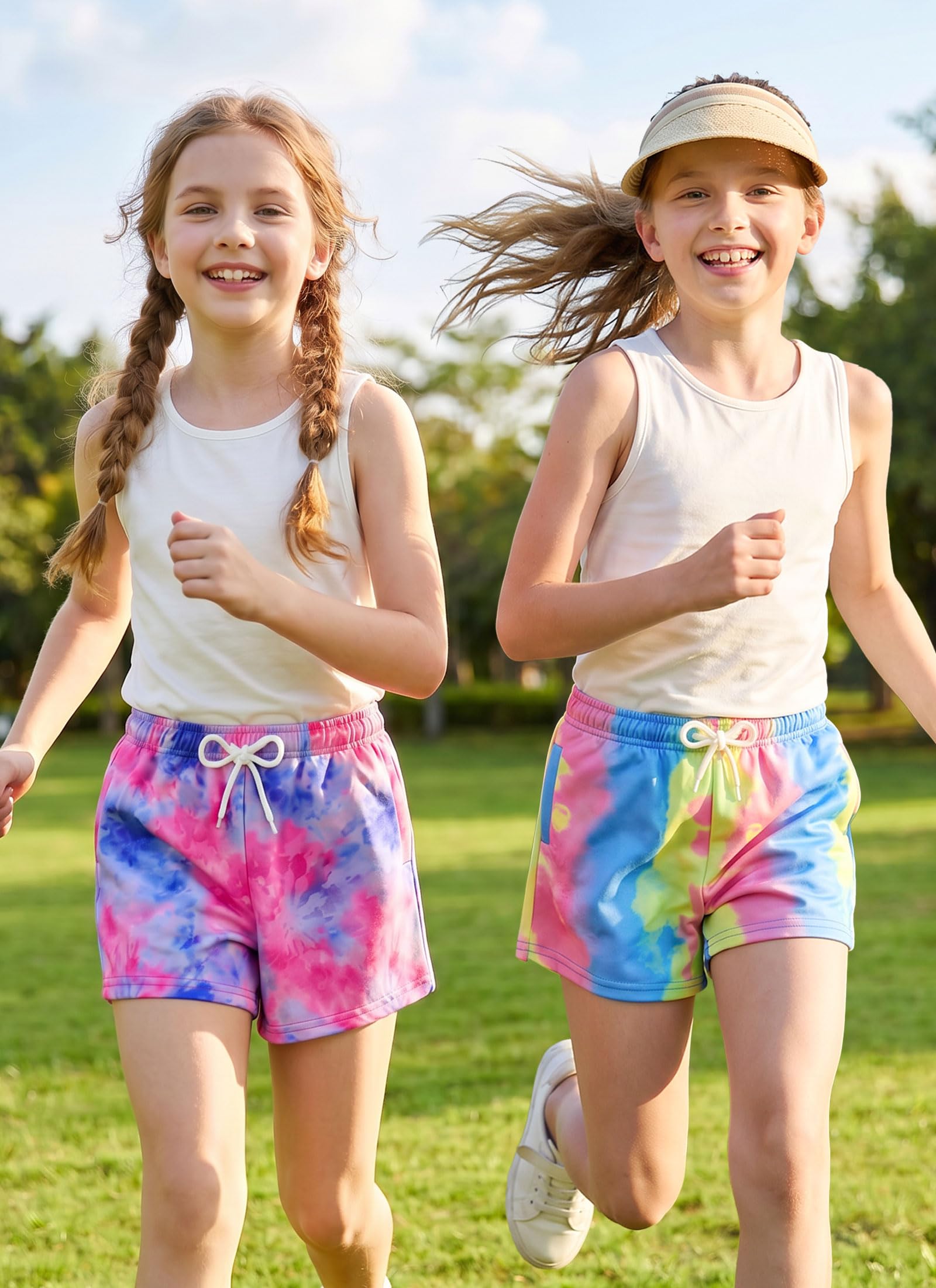 Girls wearing colorful tie dye shorts while running outdoors, comfortable kids activewear designed for movement, sports and play.