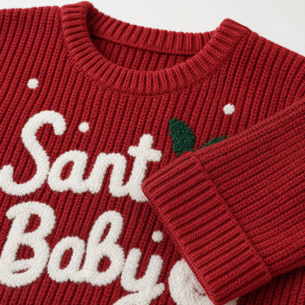 Close-up of the toddler wine red Christmas sweater showing the Santa Baby lettering, Santa graphic and festive front design.