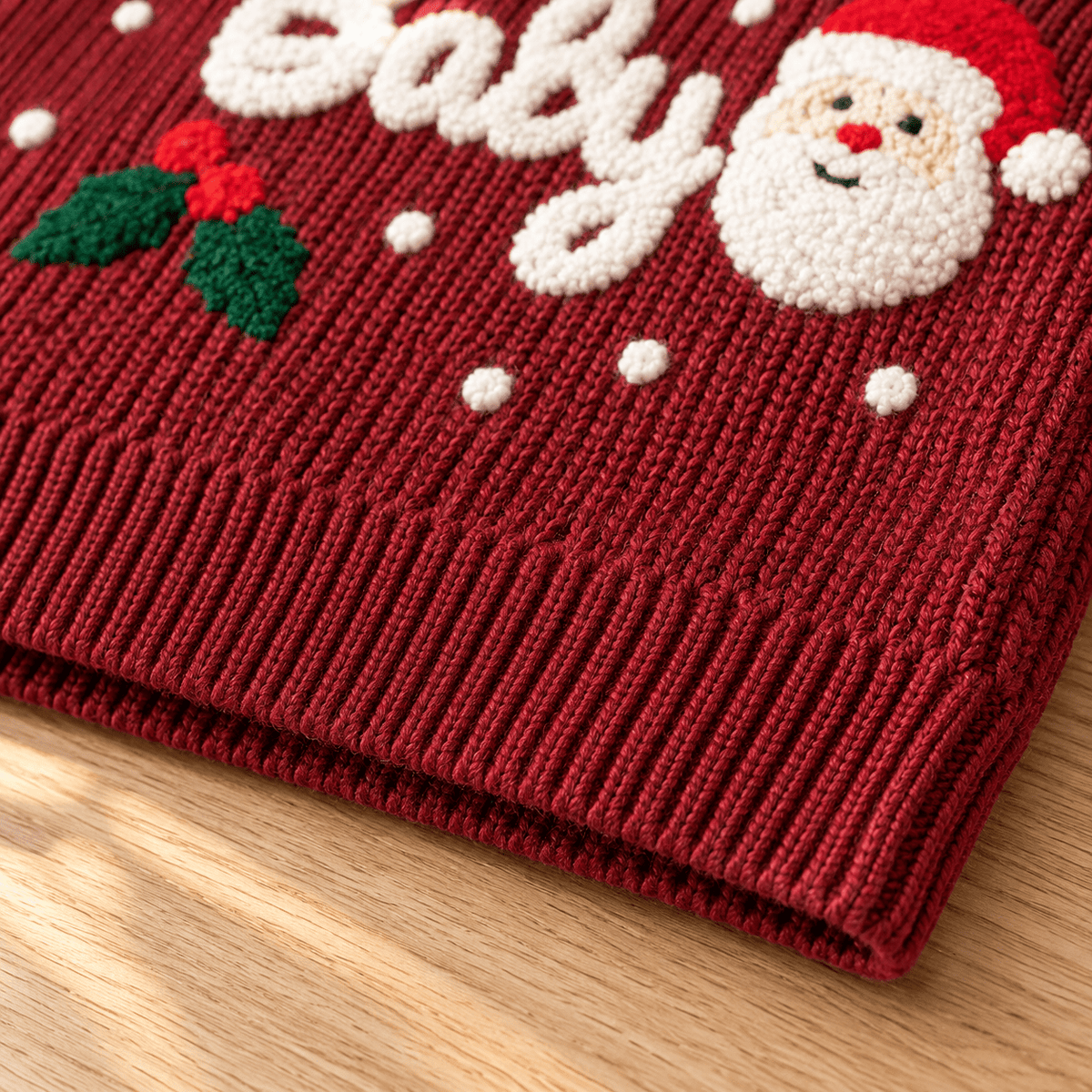 Close-up of the wine red toddler Christmas sweater showing the soft cotton acrylic fabric texture and detailed knit construction.