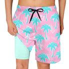 aqua blue boys swim trunks with pink palm tree print and mint compression liner