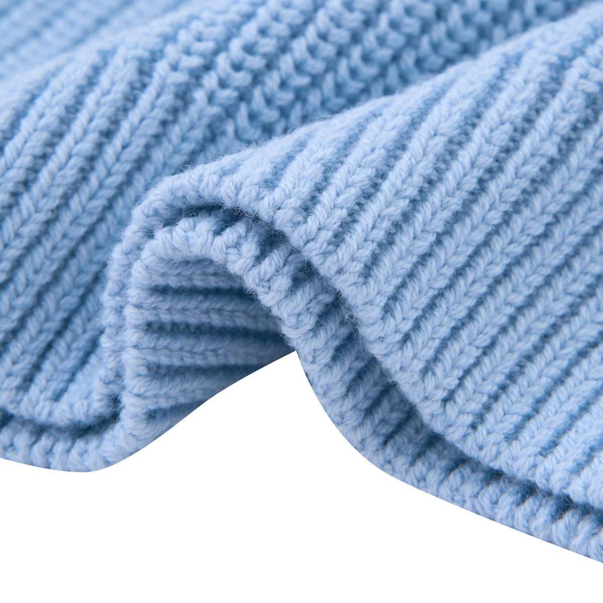 Close-up of baby blue toddler sweater fabric showing the soft cotton acrylic blend texture and knit construction.
