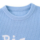 Close-up of the baby blue Big Brother sweater showing the crew neckline, ribbed trim and soft cotton acrylic fabric construction.