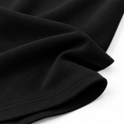 Close-up of the black girls swing dress showing the gathered waist detail and flowing A-line skirt construction.