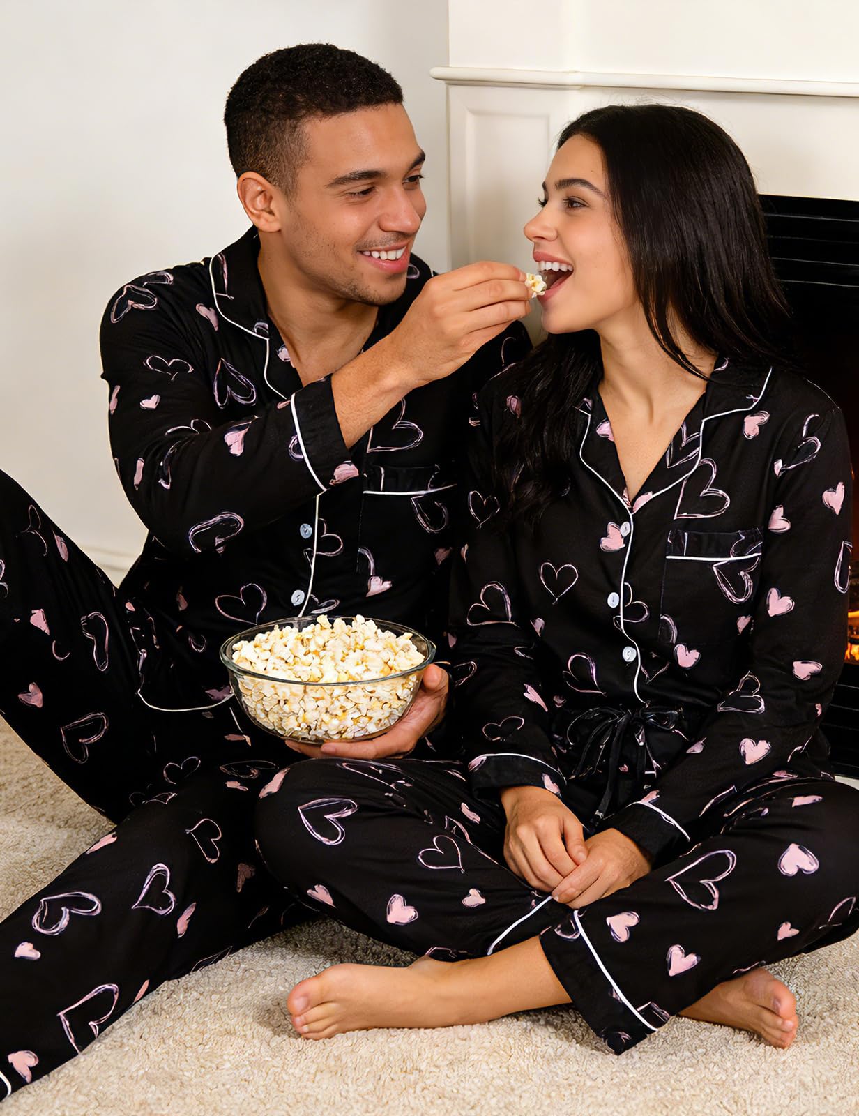 Couple dressed in coordinated Black Heart pajama sets, showing a comfortable matching look for home lounging and special occasions.