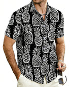 Men's black Hawaiian shirt featuring pineapple print for beach vacations.