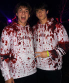 Men wearing Blood Splatter graphic hoodies together in a Halloween setting, showing the bold red horror print and casual pullover fit.
