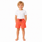 Young boy wearing orange banana print swim shorts with matching family beachwear style, comfortable kids swimwear for summer.