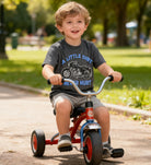 Happy boy riding a bicycle wearing a gray graphic T shirt, casual kids clothing for summer outdoor play
