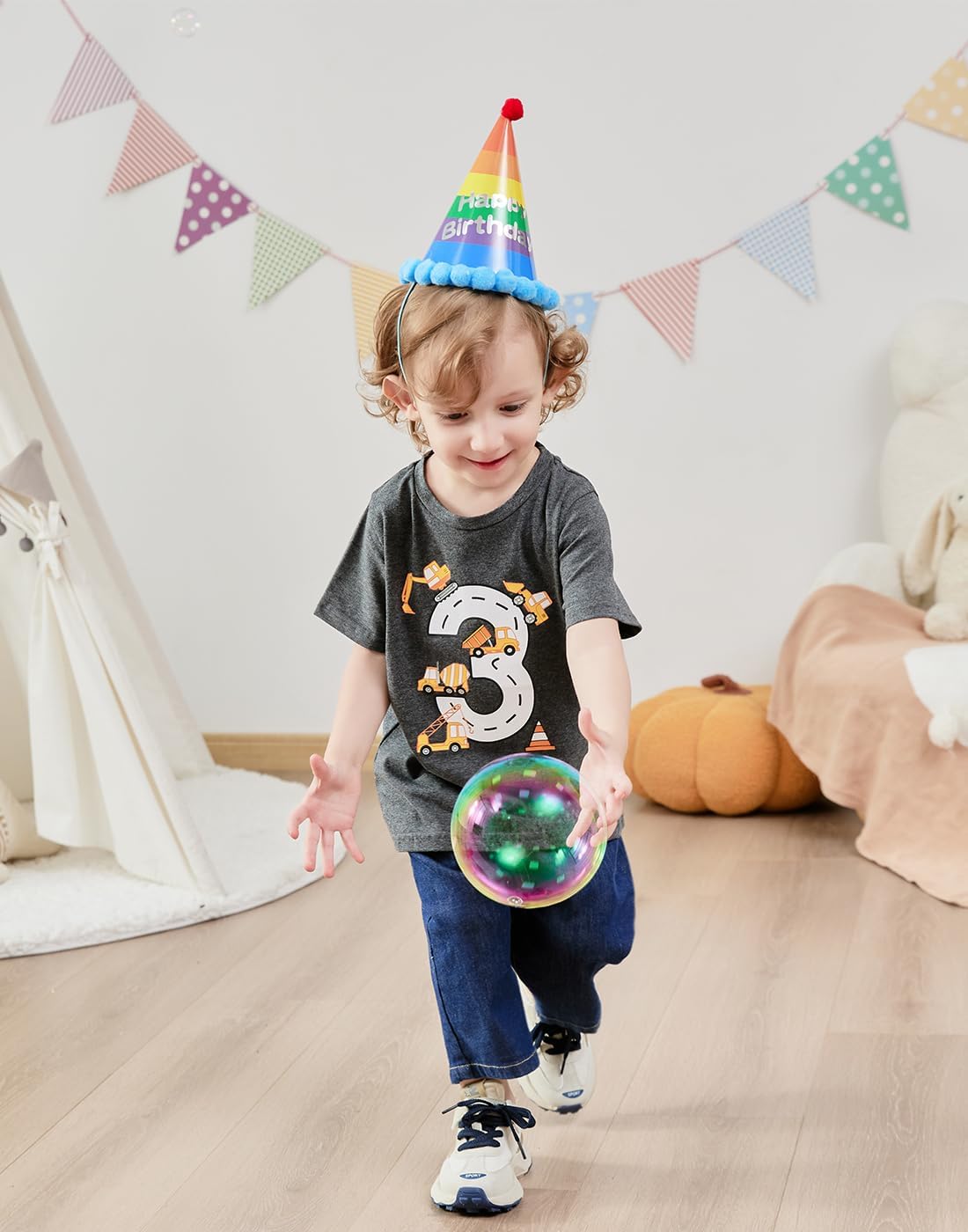Boy wearing a dinosaur birthday graphic T shirt indoors, comfortable kids outfit for birthday parties and daily activities.