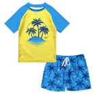 Boys Blue Hawaii swim set with yellow and blue short sleeve rash guard, palm tree graphic and matching tropical swim trunks.