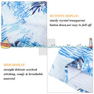 Close-up of boys blue palm tree button-down shirt showing the tropical print, fabric finish and neat seam construction.