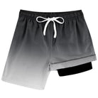 Boys gradient black swim trunks with drawstring waist and compression liner, stylish beach shorts for kids.
