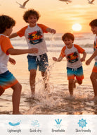 Kids wearing Orange Hawaii rash guard swim sets while playing by the ocean at sunset, designed for beach and summer water activities.