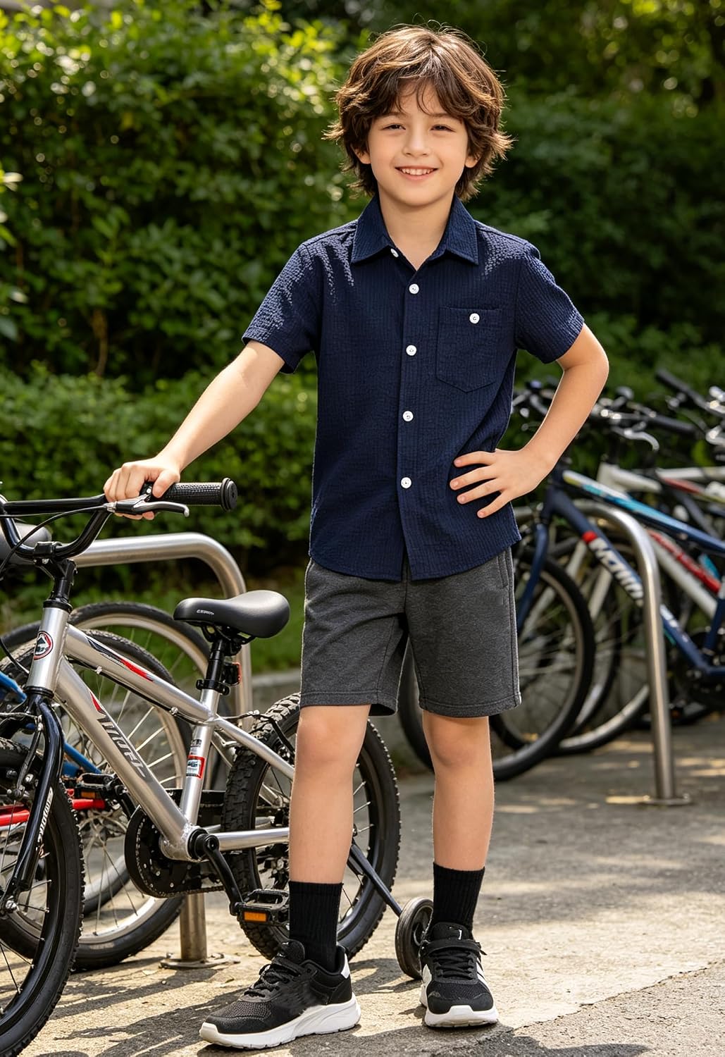 Boy riding a bicycle wearing a lightweight navy striped polo shirt for outdoor activities.