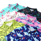 Close up details of boys polo shirt showing button collar, colorful print design and soft stretch fabric construction.