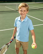 Boy wearing classic polo shirt outfit suitable for school uniforms
