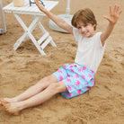 child wearing colorful tropical swim trunks for summer outdoor activities