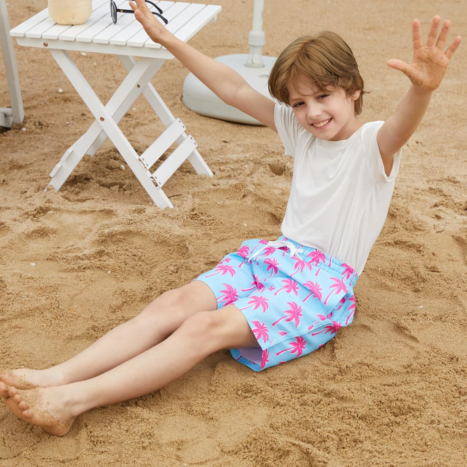 child wearing colorful tropical swim trunks for summer outdoor activities