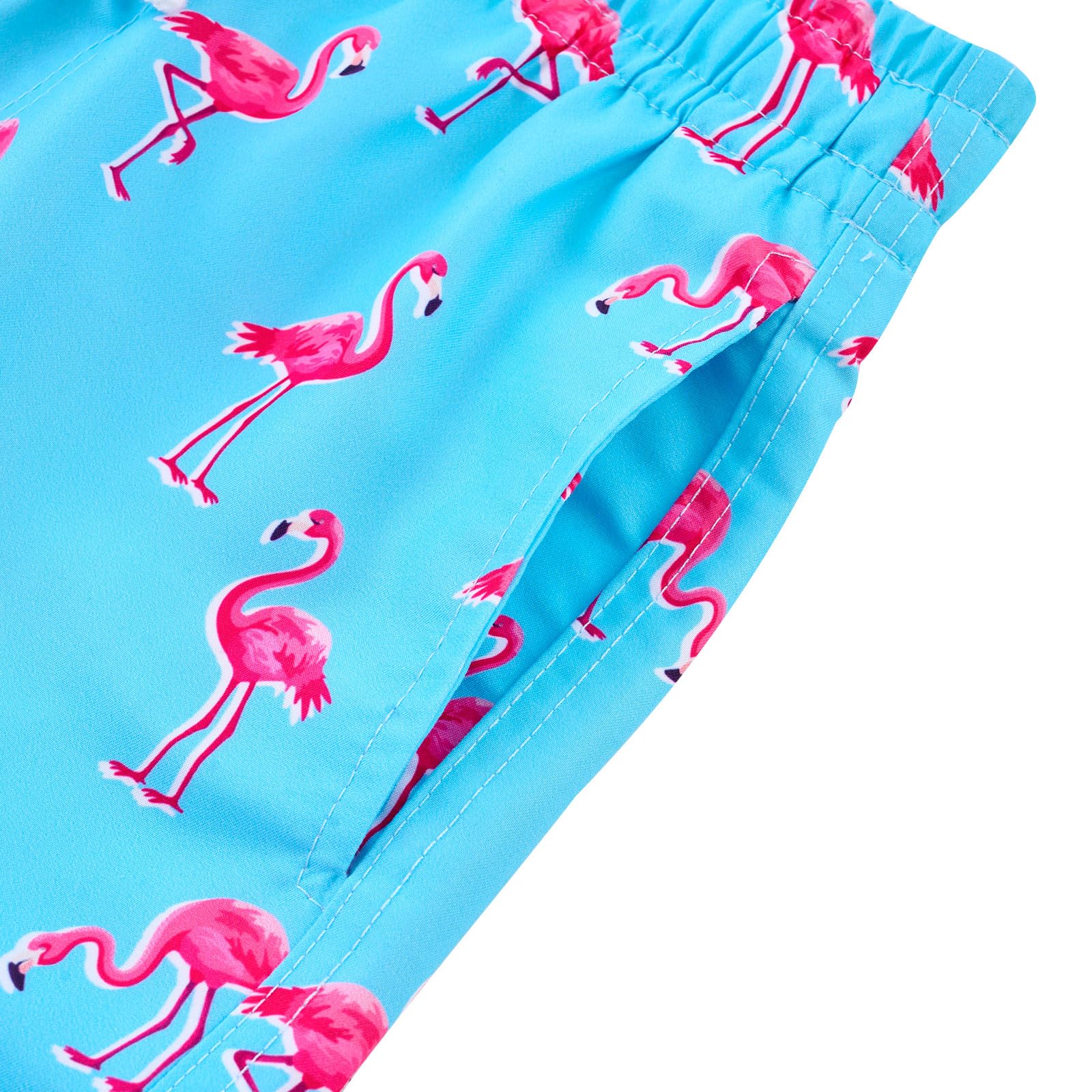 Close up of boys blue flamingo swim trunks showing the side pocket detail and practical storage design for everyday activities.