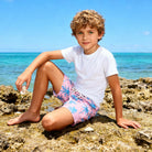 Boys tropical printed beach shorts styled for summer vacations, swimming and outdoor adventures.