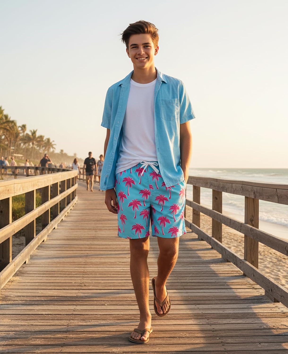 boy wearing tropical swim shorts walking near the beach resort