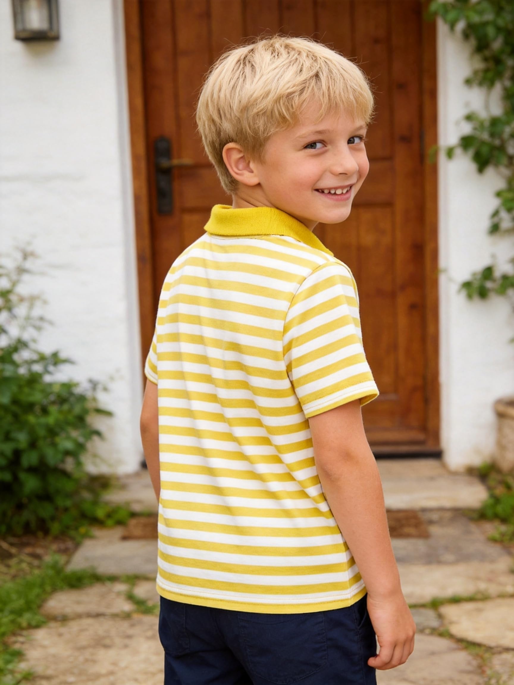 Back view of a boy wearing a yellow striped polo shirt, showing the classic collar design and comfortable fit for casual everyday wear.