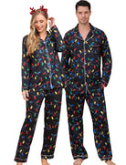 Couple wearing black Christmas light print pajamas with matching button up shirts and pants