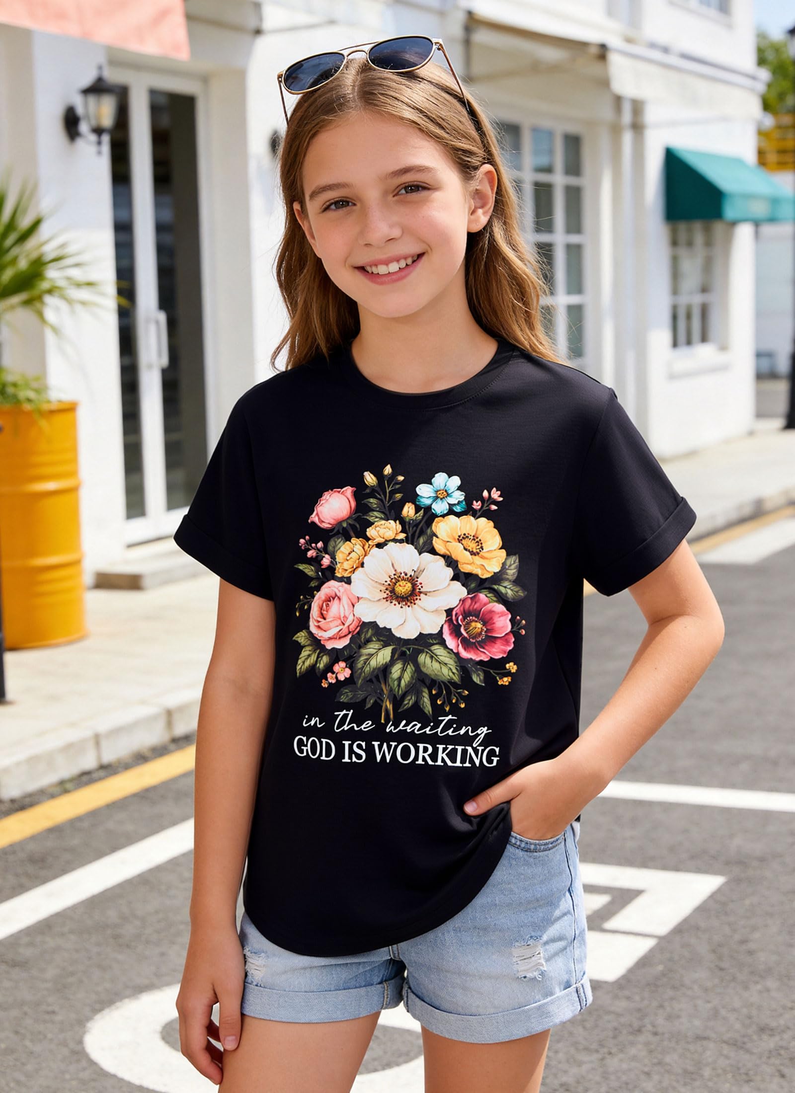 Girl wearing a black graphic T shirt with casual jeans outdoors, showing a comfortable everyday outfit style.