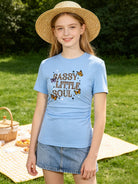 Girl wearing a blue graphic T shirt outdoors, showing a casual everyday outfit style with a comfortable ruched side design.