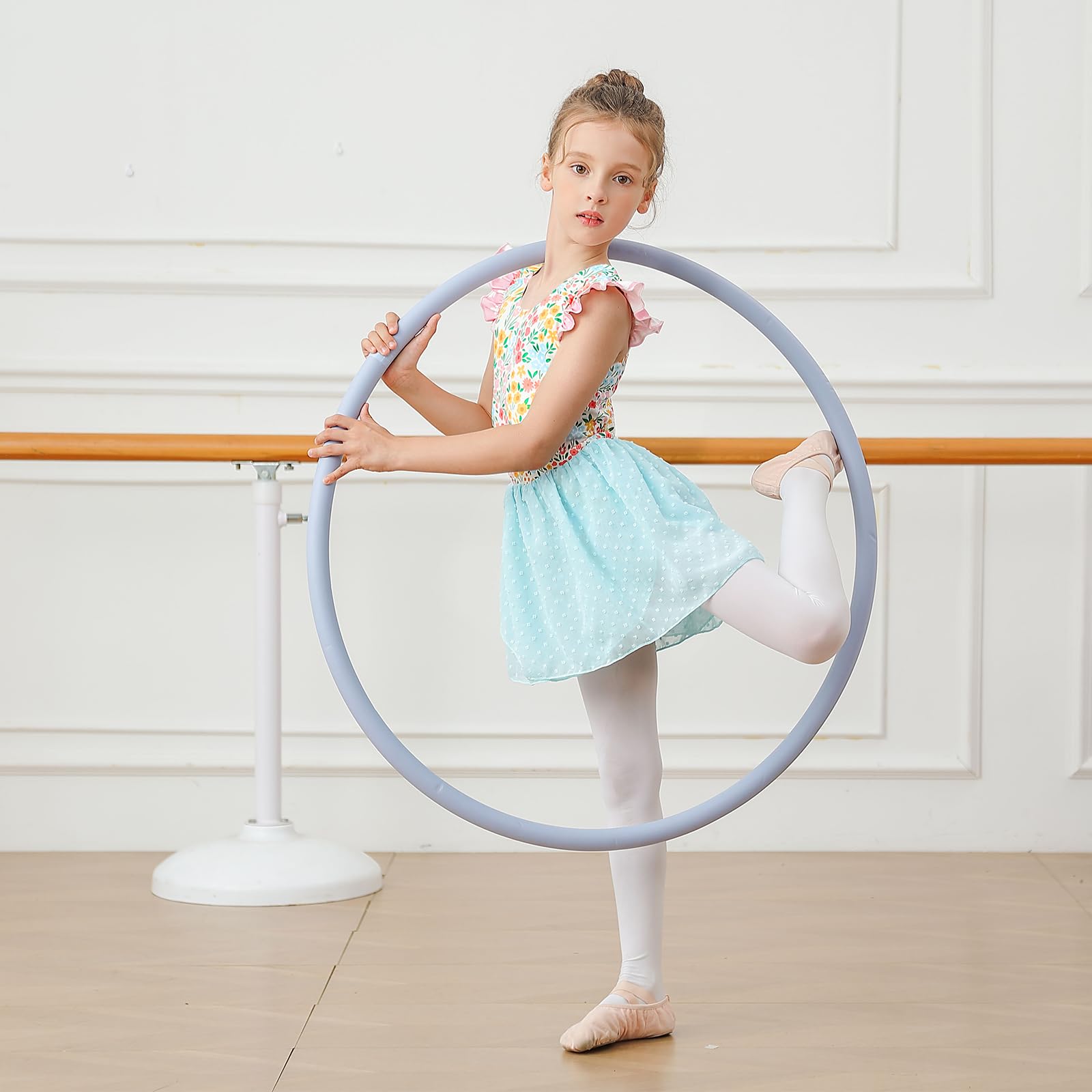 Girl wearing floral ballet leotard dress during dance practice, showing comfortable fit and graceful chiffon skirt design.