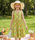 Girl wearing a green dot rainbow strap sundress outdoors, showing the comfortable fit and colorful summer style for vacations and daily wear.