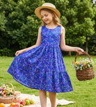 Girl wearing a navy floral rainbow strap sundress outdoors, stylish summer outfit for kids with a comfortable flowing design.