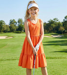 Girl wearing an orange rainbow strap sundress outdoors, colorful kids summer outfit for vacations and everyday activities.