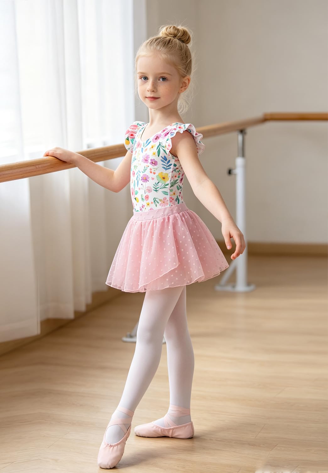 Girl wearing a pink floral ballet leotard dress with skirt, showing a comfortable dance outfit for practice and performances.