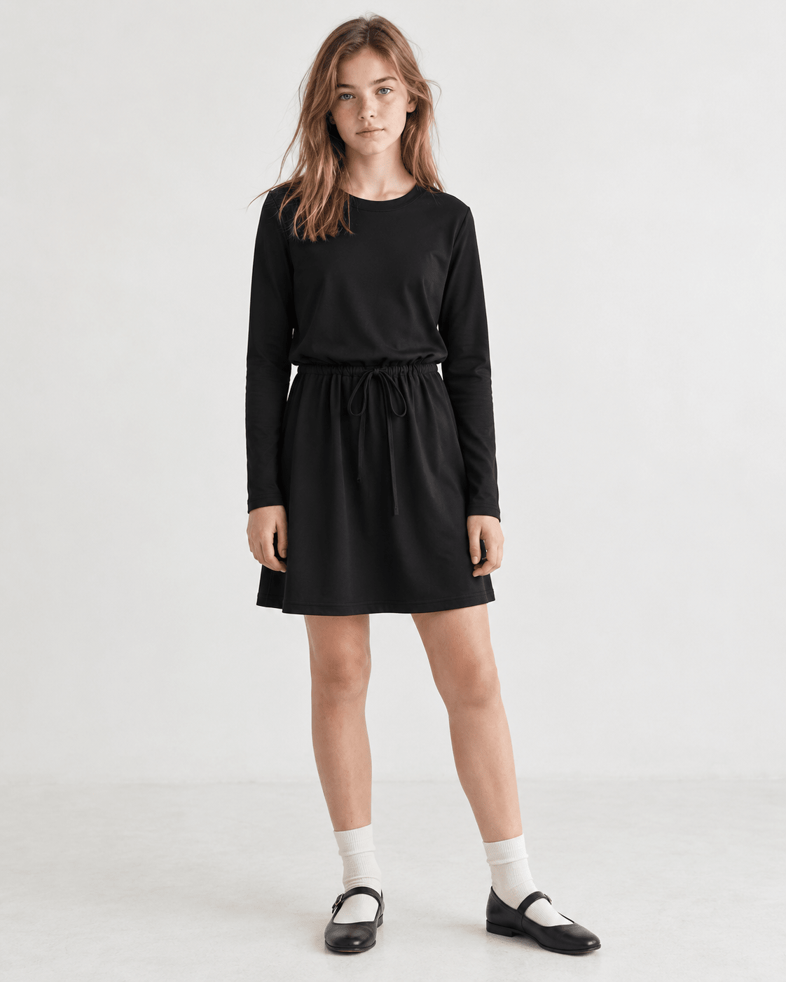 Girl styling a black long sleeve A-line dress for a casual outfit, showing the versatile silhouette and comfortable fit.