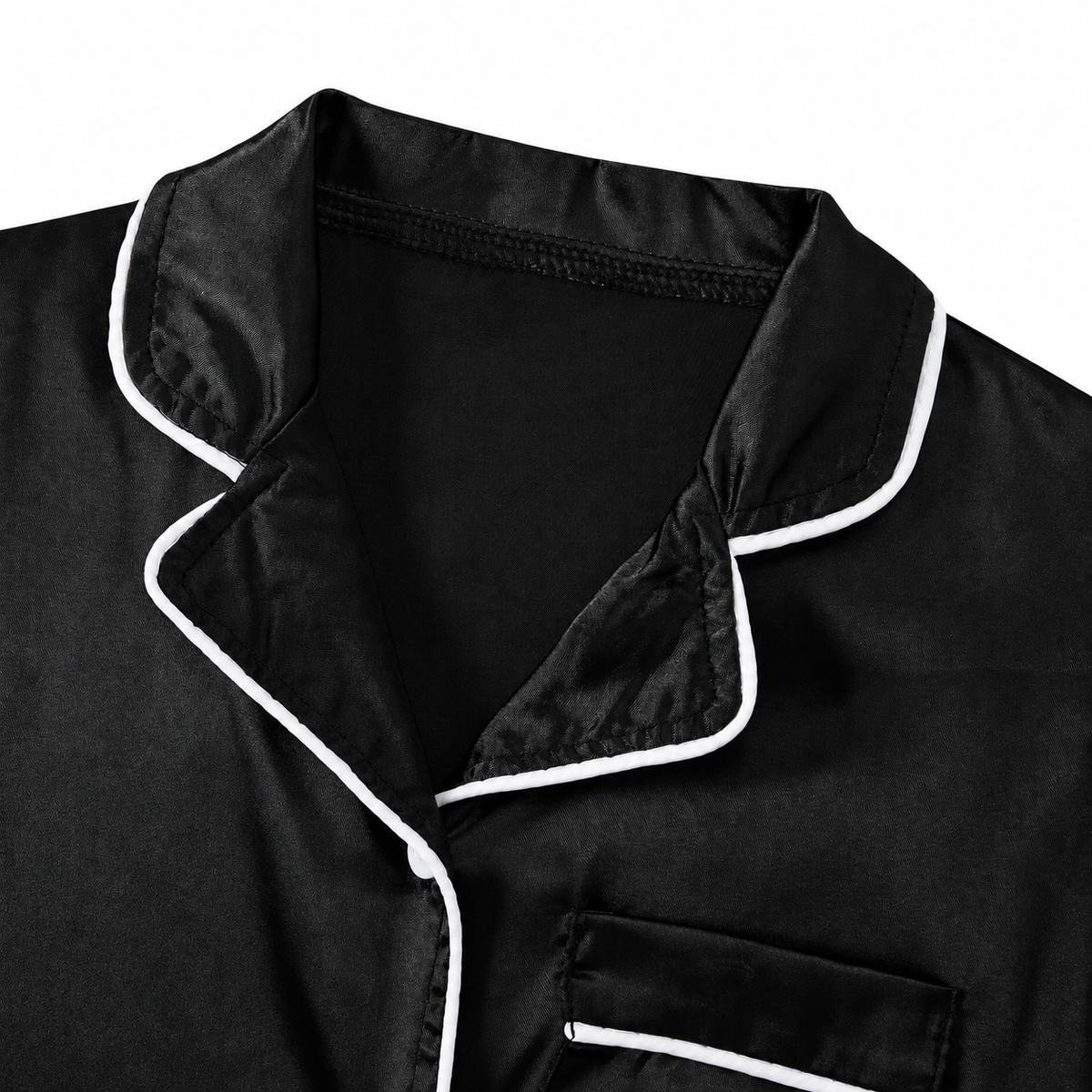 Close-up of the black girls pajama set showing the soft fabric texture, collar design and contrast trim details.