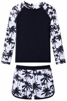 Girls black palm tree long sleeve rash guard swimsuit set with tropical print sleeves, matching swim shorts and UV protection for outdoor swimming.