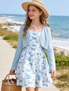 Girl styling the Blue Floral dress with cardigan for a summer holiday look.
