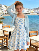Girl wearing the Blue Floral dress set while walking near the seaside during summer vacation.