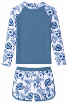 Girls blue leaves long sleeve rash guard swimsuit set with printed swim top and matching bottoms, designed for beach trips, pools and vacations.