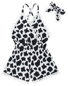 Girls black and white cow print romper dress with headband, cute toddler summer outfit with playful animal pattern.