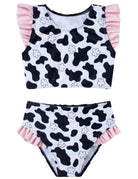 Girls black and white cow print two piece bikini set with ruffle top and matching high-waist swim bottoms for summer fun.