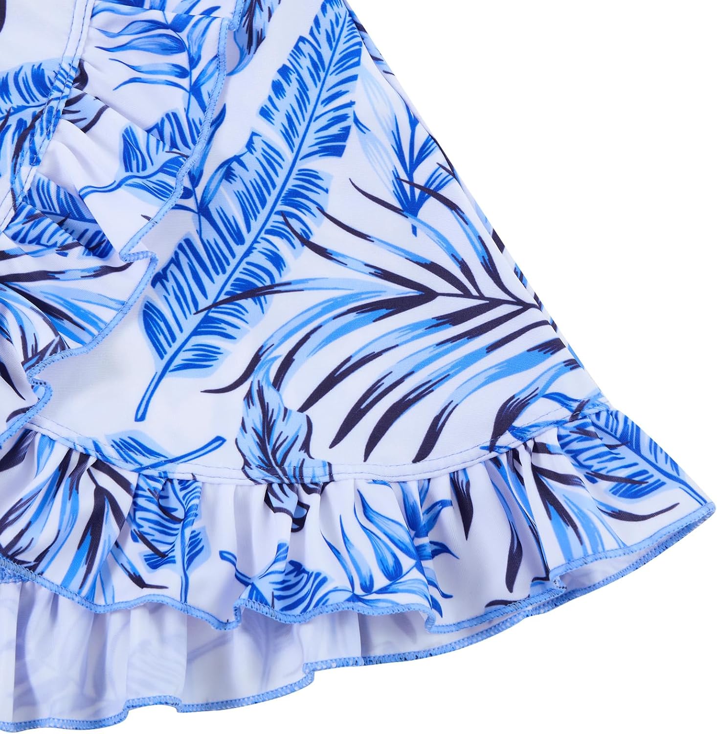 Close-up of girls blue floral swim skirt showing the tropical print, layered ruffle hem and lightweight swim fabric.